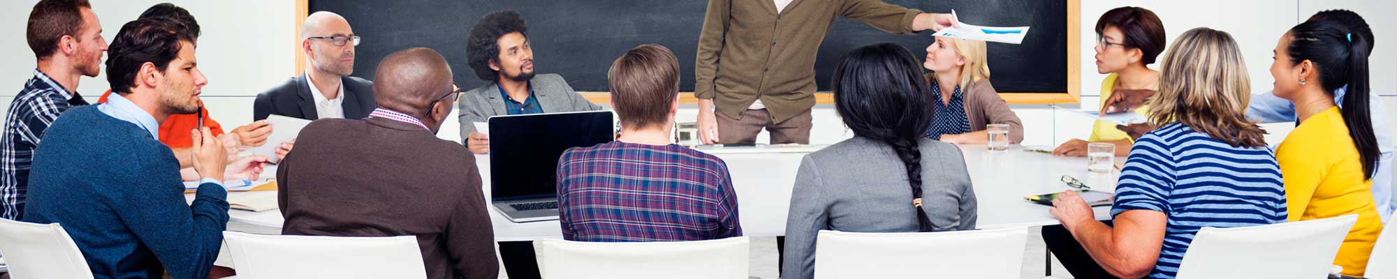 group of people sitting around a conference table